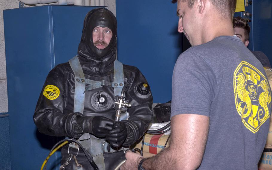 A Navy diver prepares to deploy a groundwater boom designed to prevent fuel contaminants from entering the pump system at the Red Hill well on the outskirts of Honolulu in January 2022.