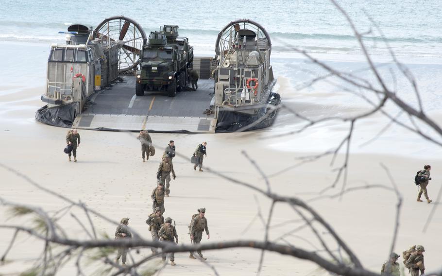 U.S. Marines and German sailors depart a U.S. Navy hovercraft during a Talisman Sabre amphibious assault near Stanage Bay, Australia, Wednesday, Aug. 2, 2023. 