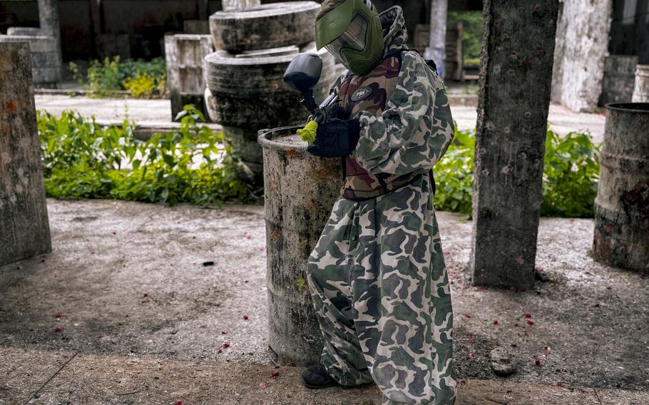A child poses for a photo  at the Paintball Arena in Cheb, Czech Republic.
