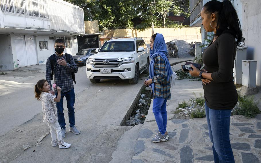 Mohammed Naiem Asadi, his wife Rahima, and their daughter, Zainab, meet with lawyer Kimberley Motley prior to leaving Kabul, Afghanistan, on June 1, 2021. Motley said the family received visas in early May to come to America after months of uncertainty. 