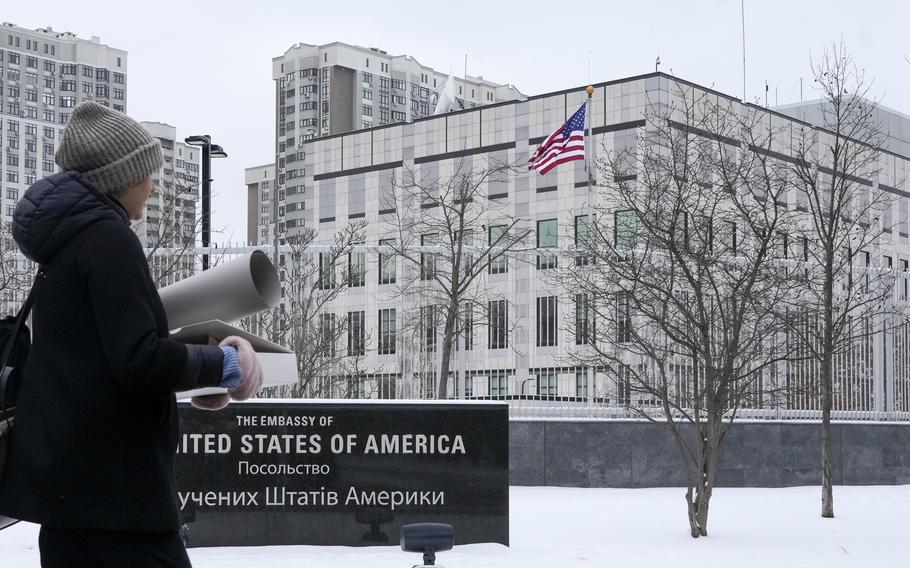A woman walks past the U.S. Embassy in Kyiv, Ukraine, Monday, Jan. 24, 2022. The State Department is ordering the families of all American personnel at the U.S. Embassy in Kyiv to leave the country and allowing non-essential staff to leave Ukraine. The move comes amid heightened fears of a Russian invasion of Ukraine despite talks between U.S. and Russian officials. 