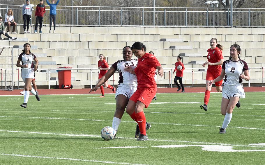 Vilseck's Kyla Blake pokes the ball away from Kaiserslautern's Chloe Mitchell on Saturday morning at Kaiserslautern High School in Kaiserslautern, Germany. Following the play are, from left, the Falcons' Valerie Vizcaino, the Raiders' Georgia Rawcliffe and Vilseck's Arianna Almanza.
