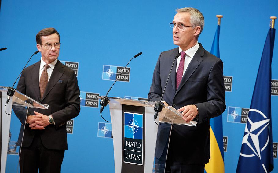 Swedish Prime Minister Ulf Kristersson, left, listens as NATO Secretary-General Jens Stoltenberg speaks at a news conference at NATO headquarters in Brussels on Oct. 20, 2022. 