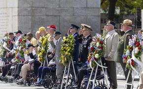 WWII veterans and supporters salute during the playing of taps Tuesday, Sept. 2, 2025 in Washington at the National World War II Memorial to commemorate the 80th anniversary of V-J Day. (Eric Kayne/Stars and Stripes)