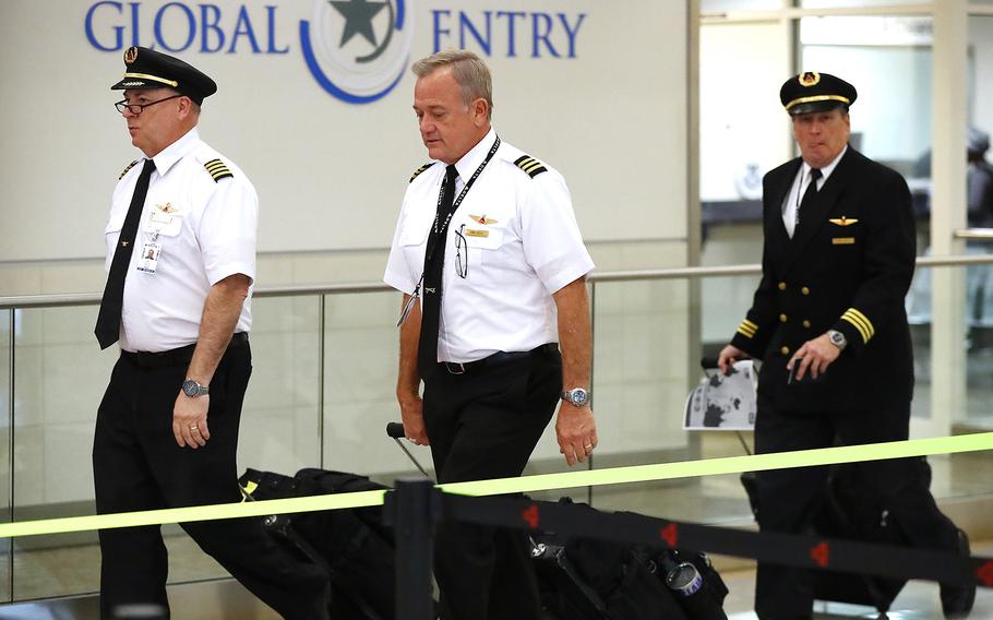 Delta Air Lines pilots arrive at Hartsfield Jackson International Airport on March 16, 2020, in Atlanta. With the pandemic restrictions lifting, Delta plans to hire 1,000 pilots by next summer.