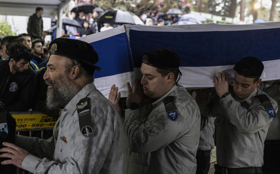 Soldiers carry the coffin of Capt. Daniel Perez, 22, during his funeral at Mount Herzl National Cemetery in Jerusalem on March 18, 2024. The Israeli military announced last month that Perez was killed on Oct. 7 and that his body is being held in Gaza. The chief military Rabbi allowed his funeral to go ahead without the body. 