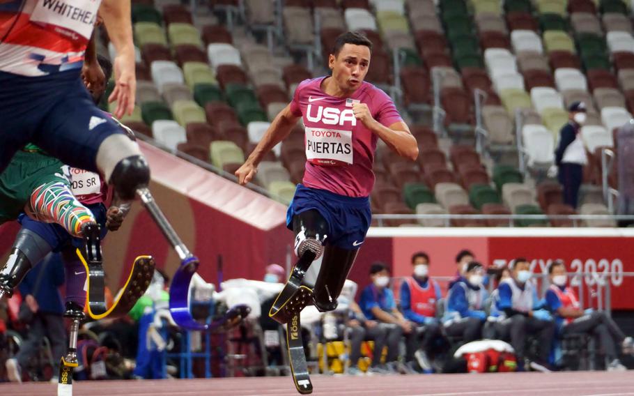 Paralympian Luis Puertas, an Army veteran who lost both legs to a roadside bomb in Iraq, runs in a 200-meter event at National Stadium in Tokyo, Friday, Sept. 3, 2021. 