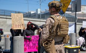 A U.S. Marine with 3rd Battalion, 7th Marine Regiment, 1st Marine Division, attached to Task Force 51, guards a federal area in Los Angeles, July 12, 2025. U.S. Northern Command is supporting federal agencies by providing military forces to protect federal functions, personnel, and property in the greater Los Angeles area. On June 7, the Secretary of Defense directed USNORTHCOM to establish Task Force 51 to oversee Title 10 forces supporting this mission. (U.S. Marine Corps photo by Lance Cpl. Andrew Whistler)