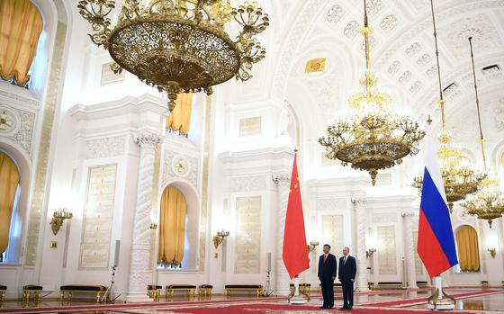 Russian President Vladimir Putin, right, and Chinese President Xi Jinping attend an official welcome ceremony at The Grand Kremlin Palace, in Moscow, Russia, Tuesday, March 21, 2023. (Alexey Maishev, Sputnik, Kremlin Pool Photo via AP)