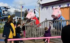 Families wait in line to meet Peppa Pig and her brother George at Peppa Pig World in Romsey, England, April 2, 2022. The park has many interactive events throughout the day for the visiting patrons to participate in. 