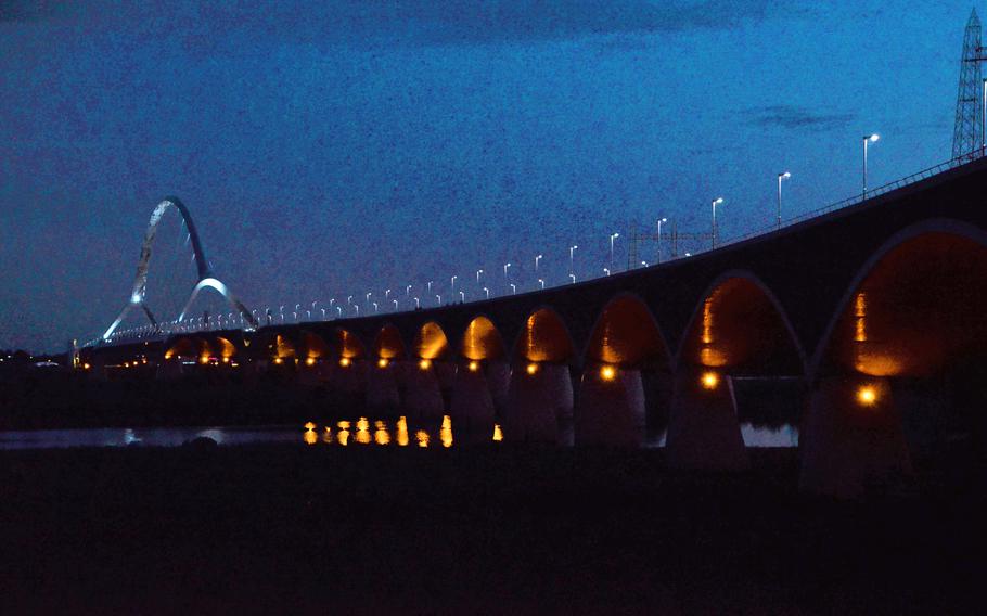 The Oversteek Bridge in Nijmegen, the Netherlands, is fully illuminated after nightfall on Aug. 13, 2021. 