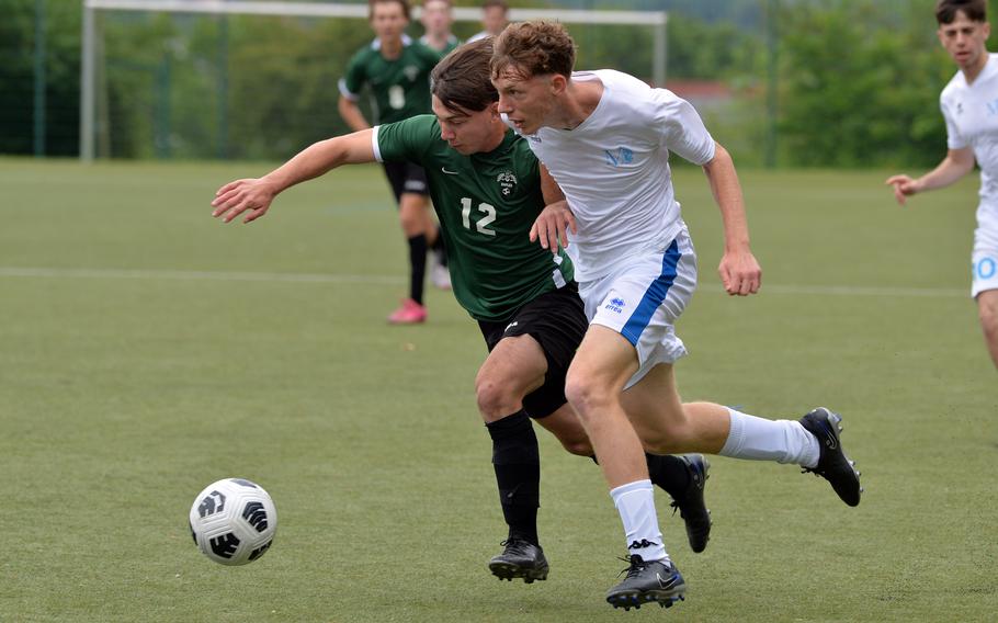Naples’ Sam Pounds, left, and Marymount’s Federico Pipitone battle for the ball in a Division II game at the DODEA-Europe soccer finals at Reichenbach-Steegen, Germany, May 21, 2024. Naples won 1-0.