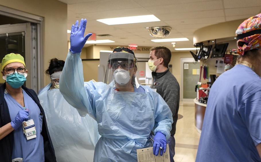 An emergency room team member gets teammates ready for the arrival of a patient at the Medical Center of Aurora on Wednesday, April 22, 2020, Colorado. 