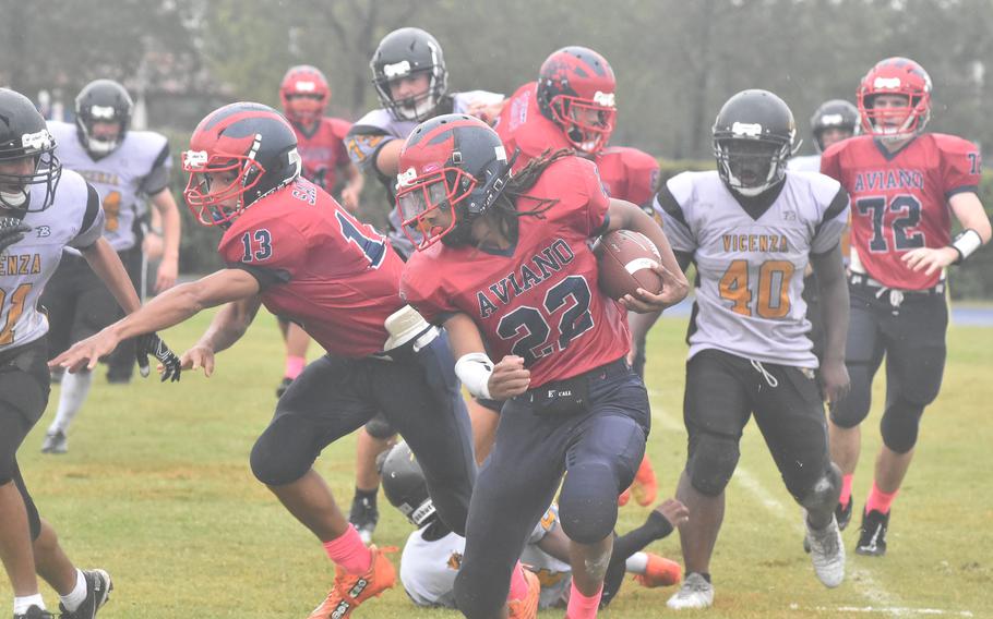 Aviano's Deon Walker checks out the defense while trying to gain some yardage Saturday, Oct. 22, 2022, in the Saints' 40-0 victory over the Cougars.