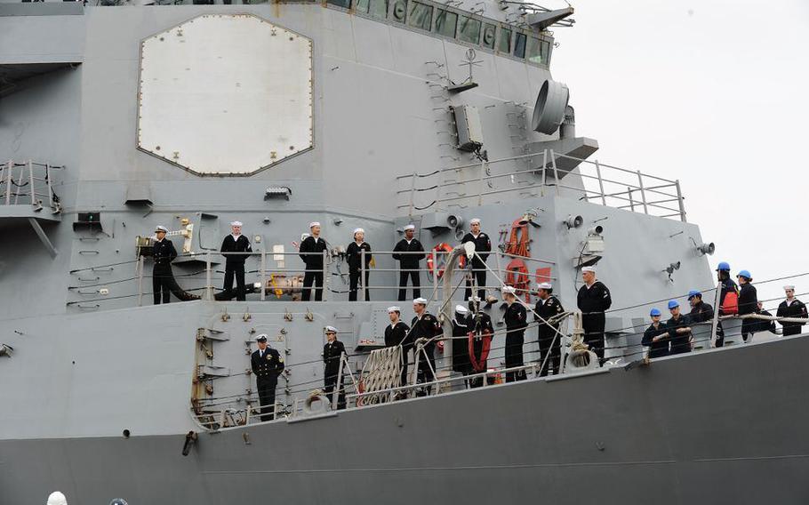 Crew of the USS James E. Williams stand ready as the ship docks in Mobile, Ala., for Mardi Gras 2019.
