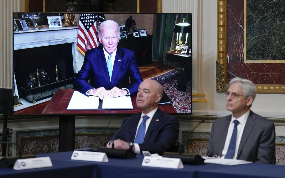 Homeland Security Secretary Alejandro Mayorkas and Attorney General Merrick Garland, right, listen as President Joe Biden speaks virtually during the first meeting of the interagency Task Force on Reproductive Healthcare Access in the Indian Treaty Room in the Eisenhower Executive Office Building on the White House Campus in Washington, Wednesday, Aug. 3, 2022.