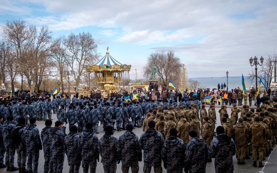 Police officers and Ukrainian soldiers attend a rally in Odessa on Jan. 22, 2022.