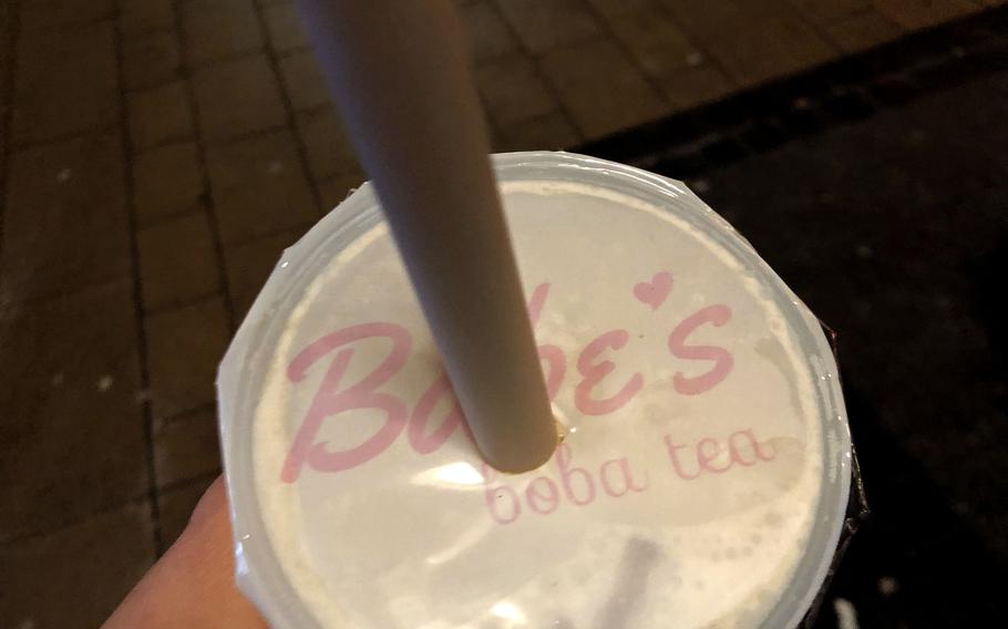 Babe's Boba Tea serves a full menu of bubble teas in a traditional plastic cup and wide straw for sucking up the boba pearls.