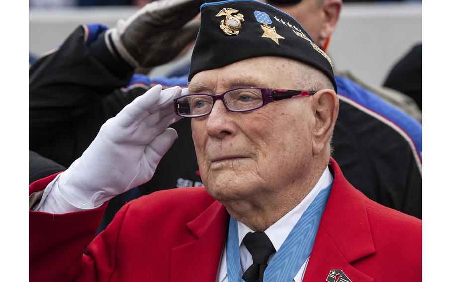 Medal of Honor recipient Hershel "Woody" Williams salutes as the national anthem is played before the Military Bowl football game at Annapolis, Md., in December 2015.