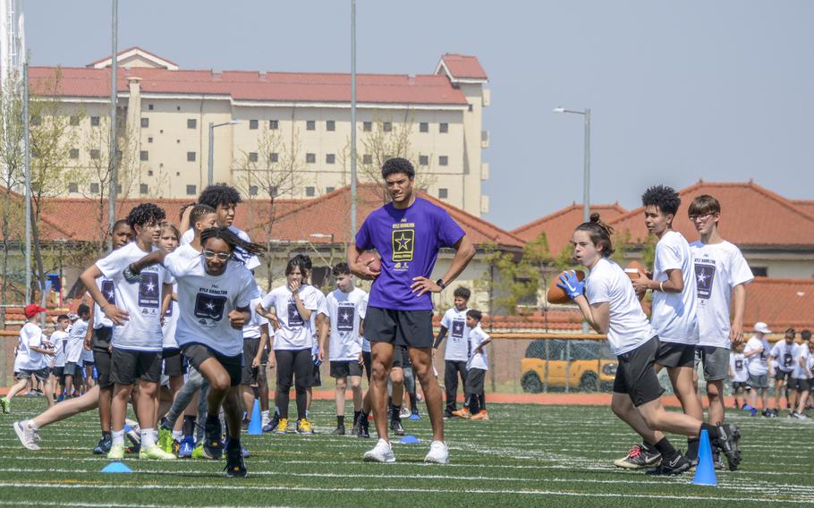 Baltimore Ravens strong safety Kyle Hamilton provides pro tips to young players at Camp Humphreys, South Korea, April 13, 2024.