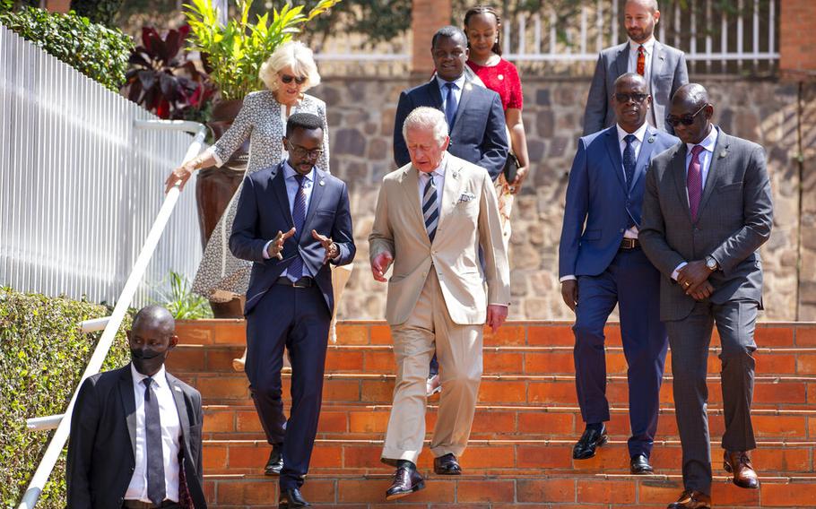 Britain’s Prince Charles, center, and Camilla, Duchess of Cornwall, above-left, arrive at the Kigali Genocide Memorial in the capital Kigali, Rwanda on Wednesday, June 22, 2022.