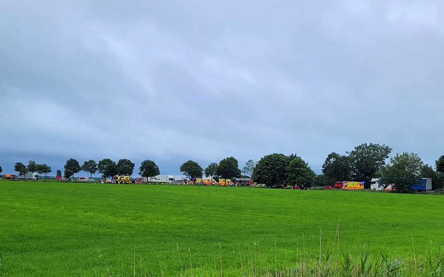 Emergency vehicles attend to the scene of a crash along route B212 in Brake, Germany, Aug. 3, 2023. Two elderly people were seriously injured in a vehicle crash involving a van with six U.S. service members, police said. 