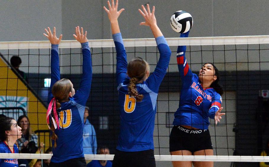Ramstein’s Jasmine Jones hits over Wiesbaden’s Rylee Ashcroft, left, and Lorelei Kemmer in the Division I championship match at the DODEA-Europe volleyball finals in Ramstein, Germany, Oct. 28, 2023. The Warriors took the title with a 25-18, 12-25,25-16,22-25,15-13 win over the Royals.