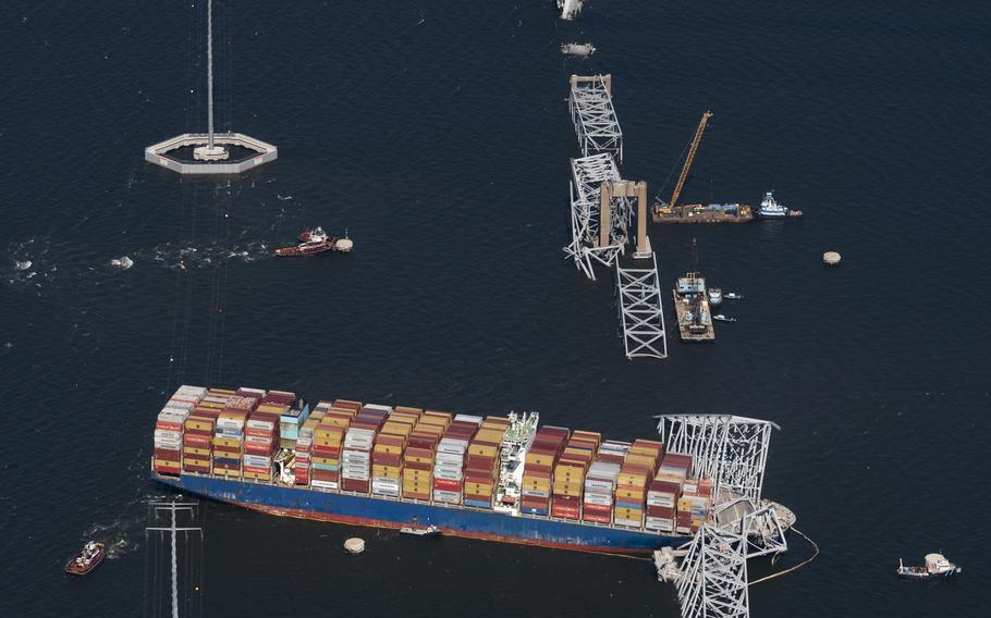 Cranes are brought in Friday to start clearing debris from where the container ship Dali crashed into Baltimore’s Francis Scott Key Bridge on March 27, 2024. 