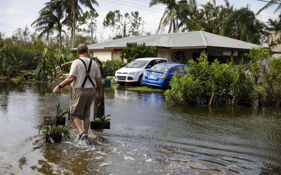 A resident walks home in the aftermath of September’s Hurricane Ian in Fort Myers, Fla. 