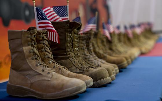 U.S. Airmen from the 332nd Air Expeditionary Wing honor the daily estimated number of veterans who take their own lives, symbolized by 22 pairs of boots in recognition of Suicide Prevention Month Sept. 8, 2021, from an undisclosed location somewhere in Southwest Asia. Suicide Prevention Awareness Month stresses the importance of mental health and encourages individuals to seek help if they need it. (U.S. Air Force photo by Senior Airman Karla Parra)