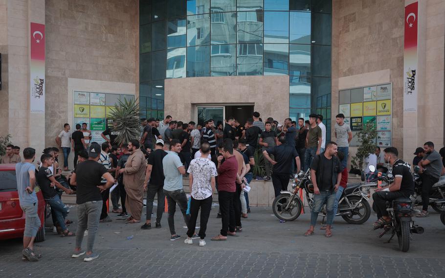 Palestinian youths gather at the Turkish visa office in the Gaza Strip on Sept. 5 to apply for work visas.