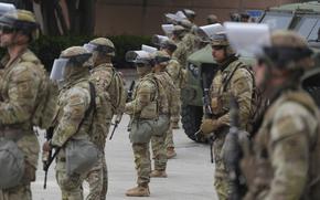 Troops in tactical gear in formation.