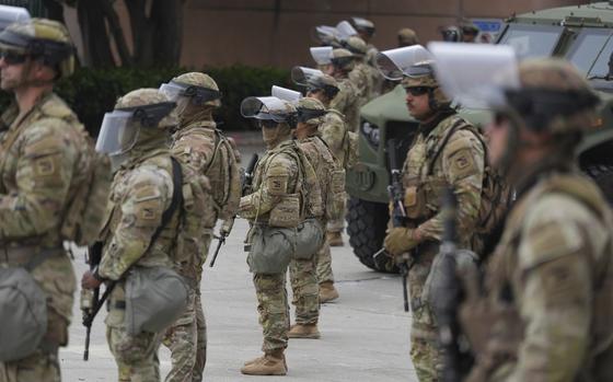 Troops in tactical gear in formation.