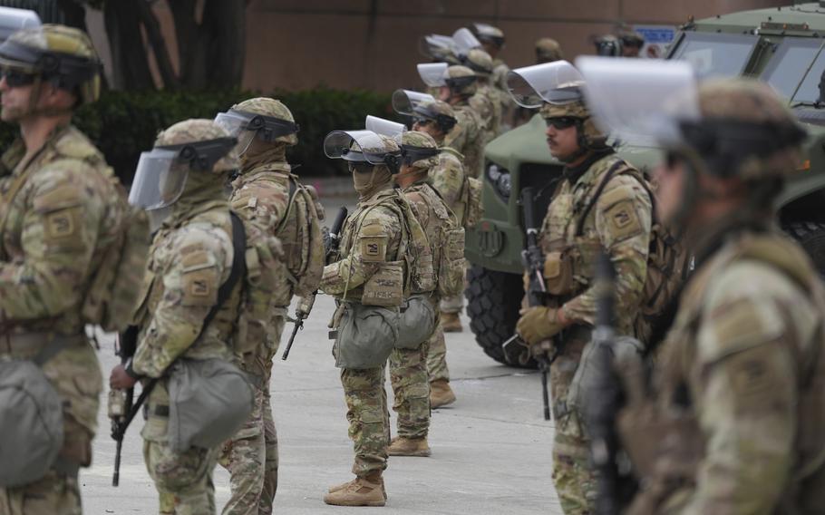 Troops in tactical gear in formation.