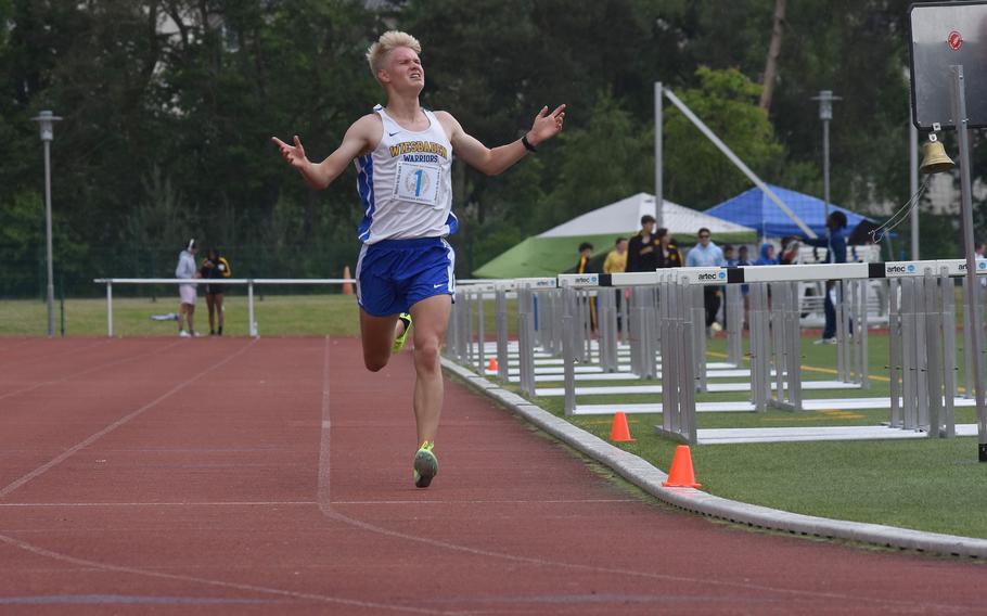 Wiesbaden junior Luke Jones raises his arms in victory while crossing the finish line in the 3,200-meter run. Jones, the defending European champ, won the race in 9:37.98, in the first day of the DODEA-Europe track and field championships in Kaiserslautern, Germany, on Thursday, May 23, 2024.