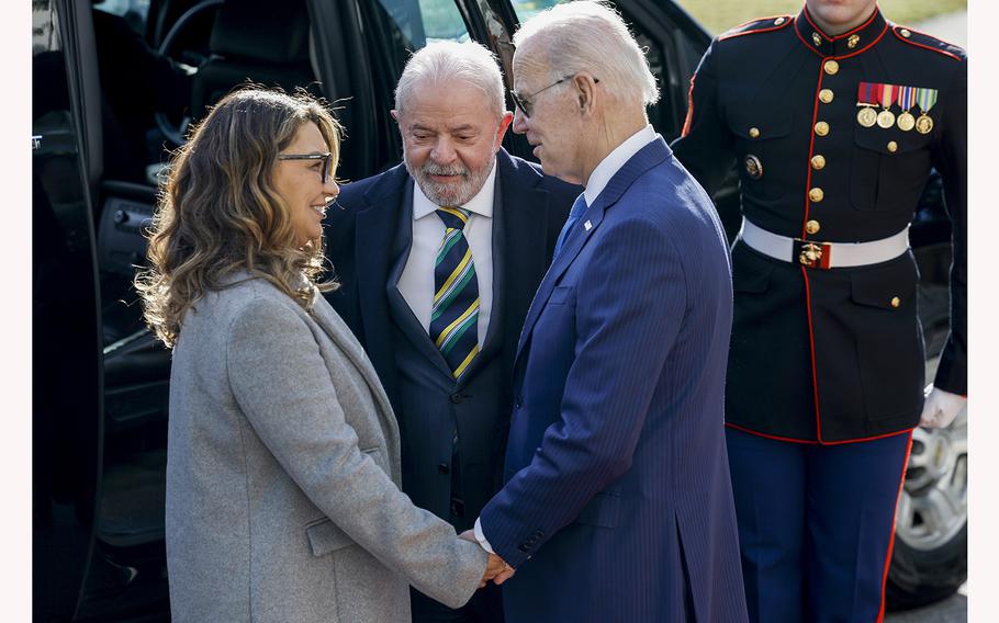U.S. President Joe Biden greets Jania Lula da Silva, the wife of Brazil’s President Luiz Inacio Lula da Silva, center, during an arrival ceremony at the South Portico of the White House on Feb. 10, 2023, in Washington, D.C. 