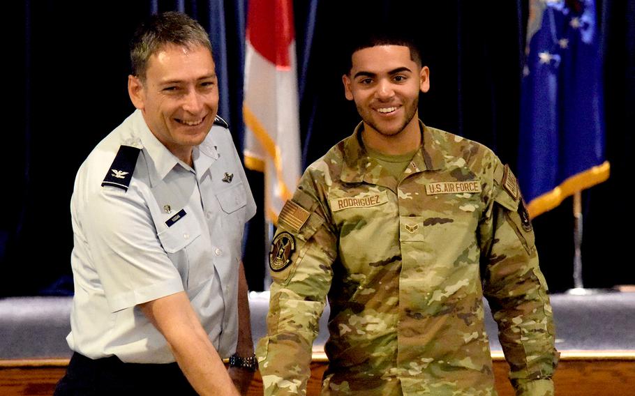 Col. Andrew Roddan and Airman 1st Class Renny Rodriguez cut the cake at the 374th Airlift Wing's 75th birthday luncheon at Yokota Air Base, Japan, on Aug. 16, 2023.