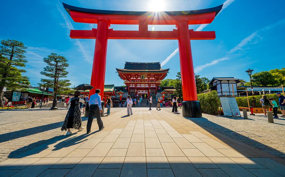 The morning sun peeks over the entrance to Fushimi Inari Shrine in Kyoto, Japan, May 28, 2025.
