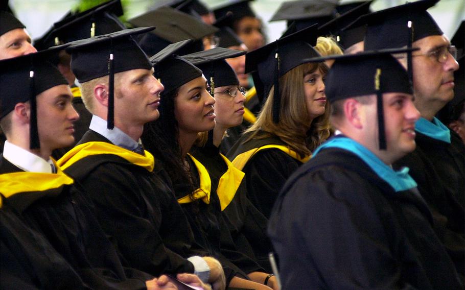 Graduates listen to speakers at the University of Maryland Global Campus commencement ceremony in Eppelheim, Germany, in 2001.