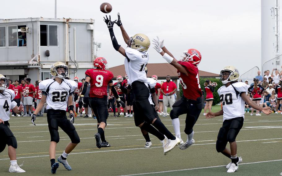 Humphreys' Brian Taylor goes up for an interception in front of Nile C. Kinnick's Michael Torres.