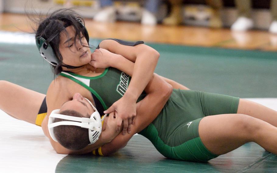 Kubasaki High School’s Gwen Pantaleon locks onto Kadena’s Jayden Green last year at Camp Foster, Okinawa.