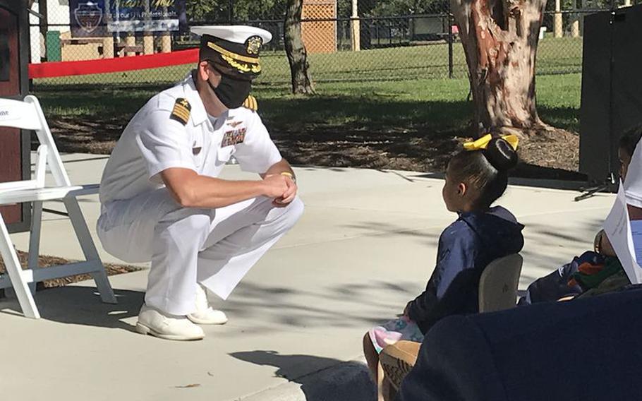 Capt. Jonathan Kine, commanding officer Naval Support Activity Hampton Roads chats with some of the children at the October reopening of Sewells Point Child Development center. The Navy has eased its rules on masks, saying they are no longer required indoors at Hampton Roads installations.