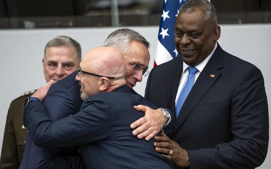 NATO Secretary-General Jens Stoltenberg and Ukrainian Defense Minister Oleksii Reznikov hug each other with U.S. Defense Secretary Lloyd Austin and Gen. Mark Milley, chairman of the Joint Chiefs of Staff, looking on ahead of the Ukraine Defense Contact Group meeting in Brussels on Thursday, June 15, 2023.