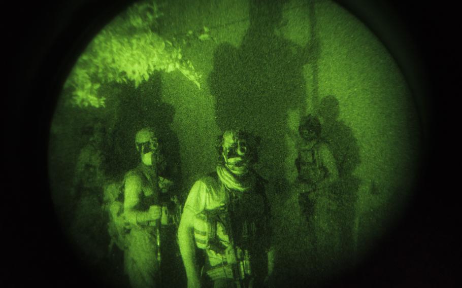 An elite special forces unit conducts a clearing operation in an area under Taliban control in Kunduz, Afghanistan, in July 2021. 