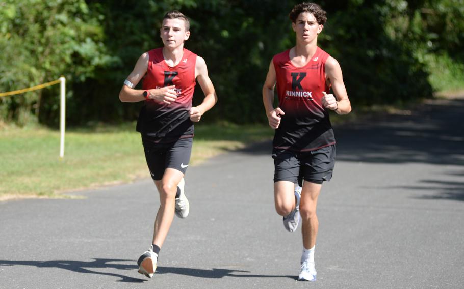 Caleb Mintling and Emmett McNamara run together.