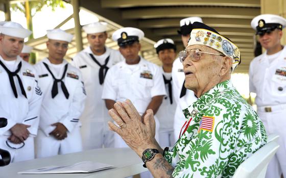Sterling Cale, a surivor of the 1941 attack on Pearl Harbor, speaks to sailors near the USS Arizona Memorial in Pearl Harbor, Hawaii, in 2013.