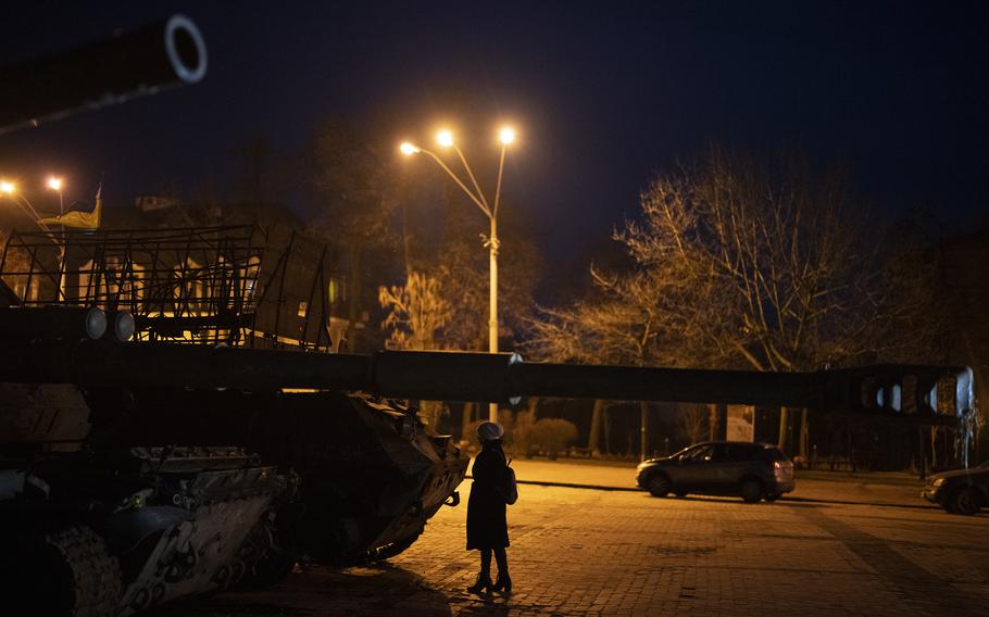 A woman stands in front of a display of destroyed Russian tanks and armoured vehicles in downtown Kyiv, Ukraine, Friday, Jan. 20, 2023.
