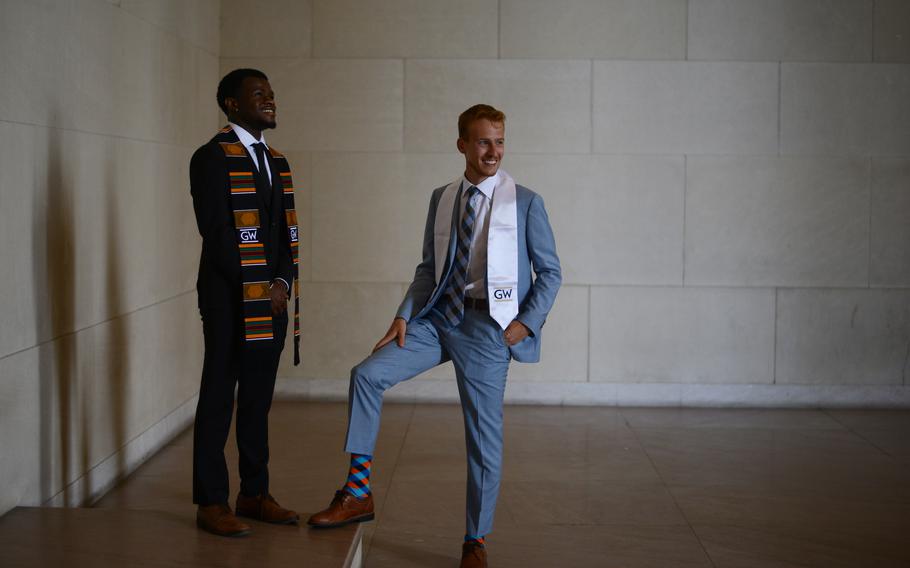 Bryce Lawson, 22, left, and his fellow George Washington University graduate and roommate Sam Linder, 22, pose for a portrait at the Lincoln Memorial in Washington, D.C., on May 18, 2022. Both said they have fond memories of the memorial since they spent time there during their studies at GWU. 