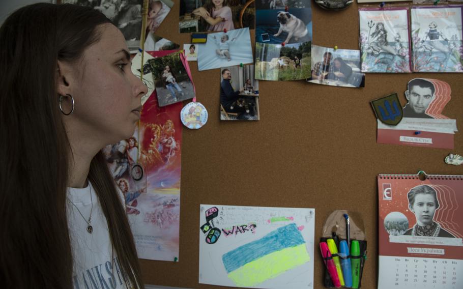 Yuliia Sirenko, 28, as she looks at photos of her husband at her home in Kharkiv, Ukraine on Aug. 11, 2022. 