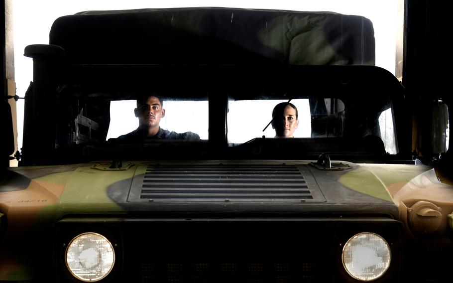 Marvin Fuentes decided to stay on in the Marines, where he is a Motor Transport mechanic, and so did Alexandria McFadden, who is in Motor Transport. They are in a Humvee in a repair shop at Camp Pendleton on Wednesday, Oct. 12, 2022.